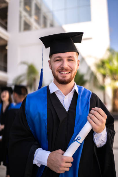 Portrait of young graduate man on his graduation